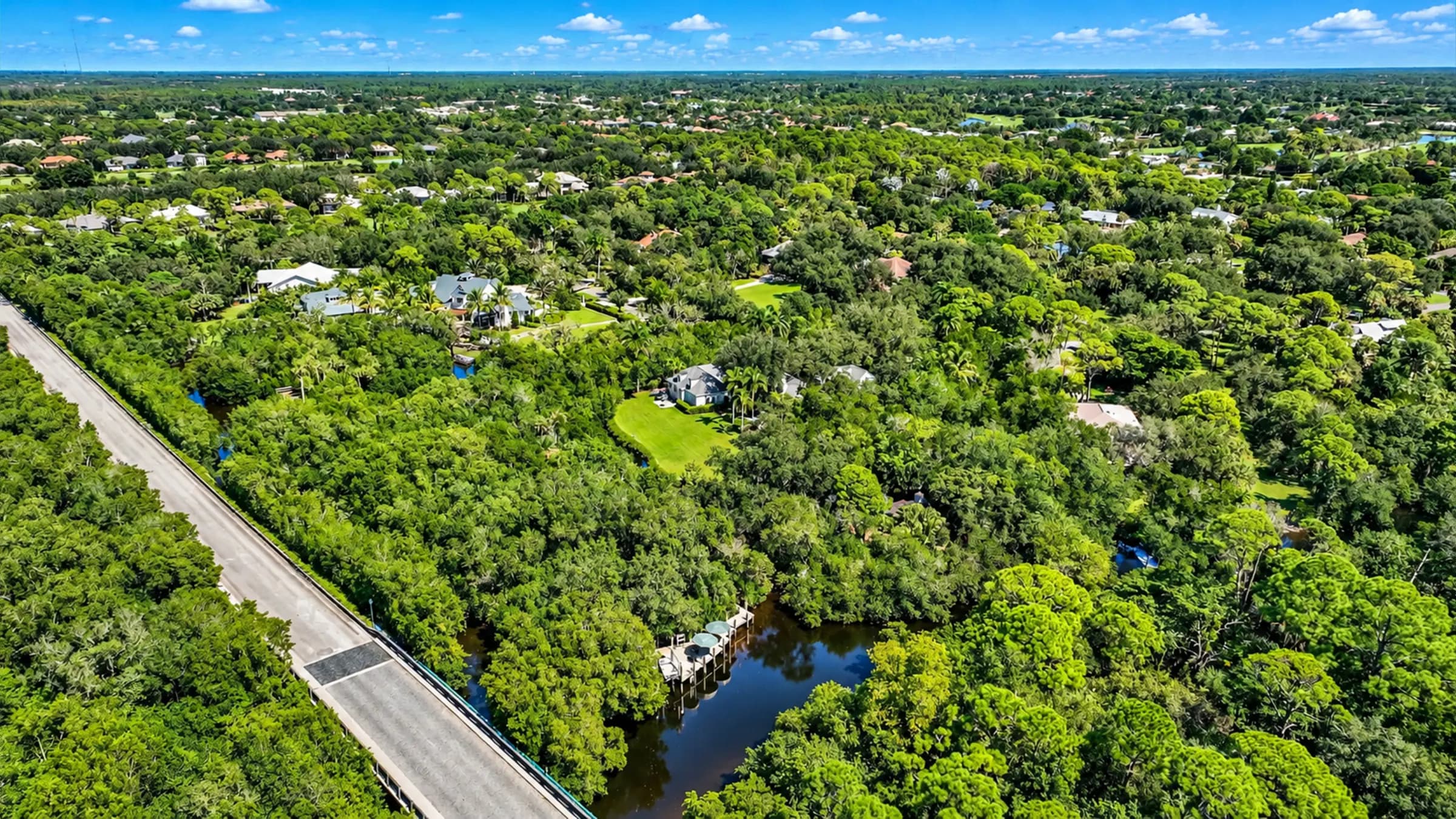 The Cocohatchee River winding through the estate's mangrove canopy