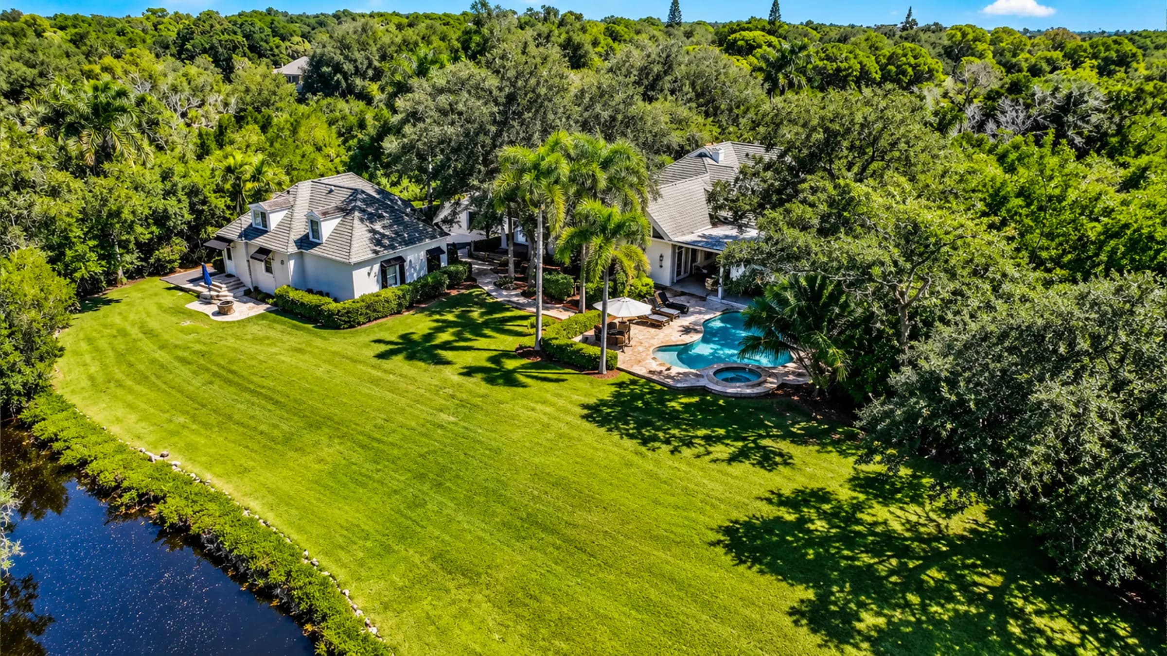 The main lawn running down to the Cocohatchee River